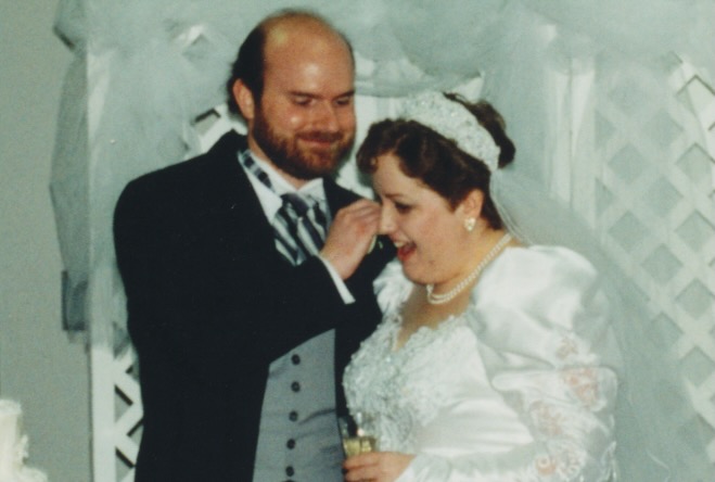 Jim whispering in Melinda's ear. Melinda looking excited